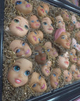 Muck N Brass Posters, Prints, & Visual Artwork Toys R Art Doll Faces in a navy frame