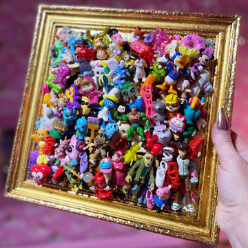 Muck N Brass Toys R Art 100 in a small vintage gold frame